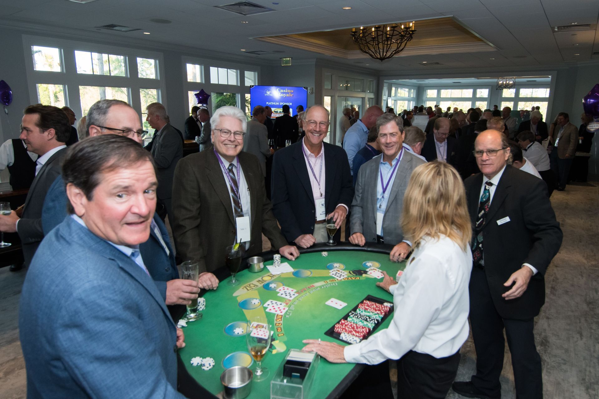 A group of people are playing a game of poker at a table.