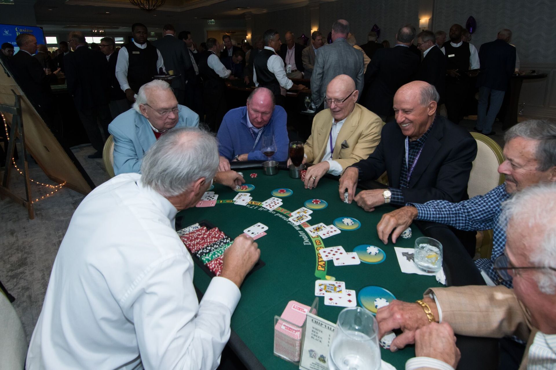A group of men are playing a game of blackjack