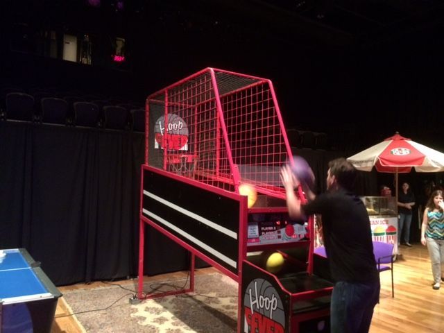 A man is playing a game of basketball on a stage.