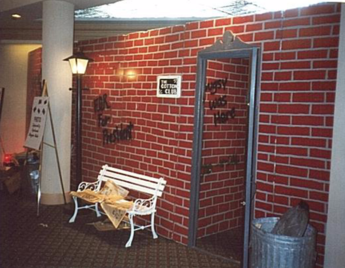 A brick wall with a white bench in front of it