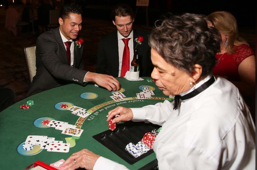 A group of people are playing a game of blackjack at a table.