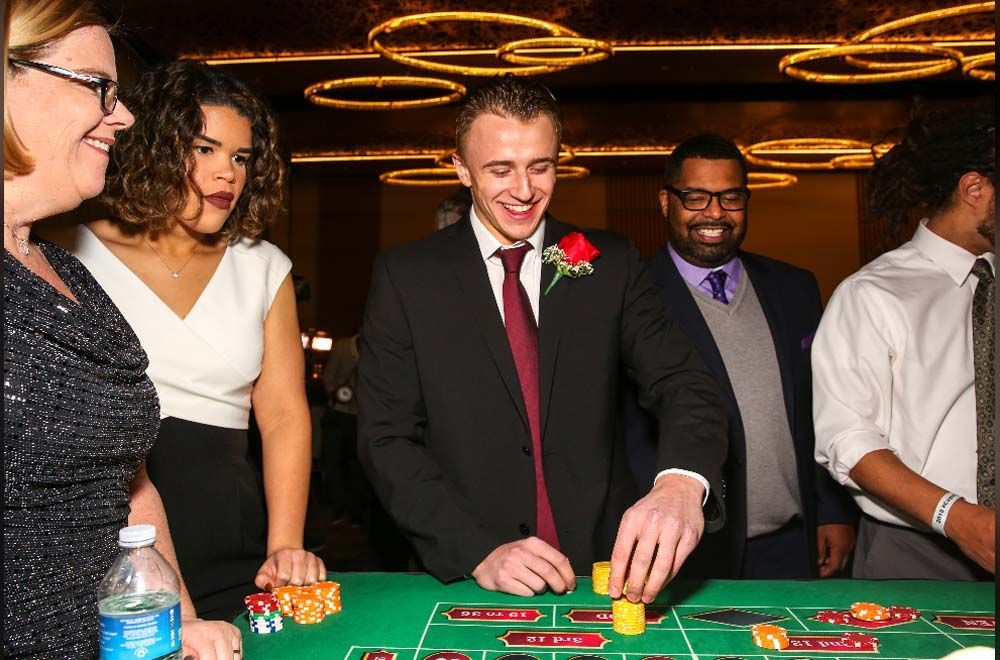 A group of people are playing roulette in a casino.