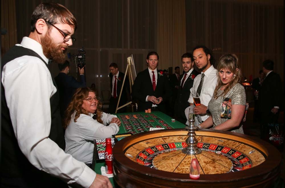 A group of people are playing roulette in a casino