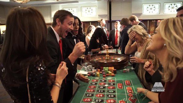 A group of people are playing roulette in a casino.