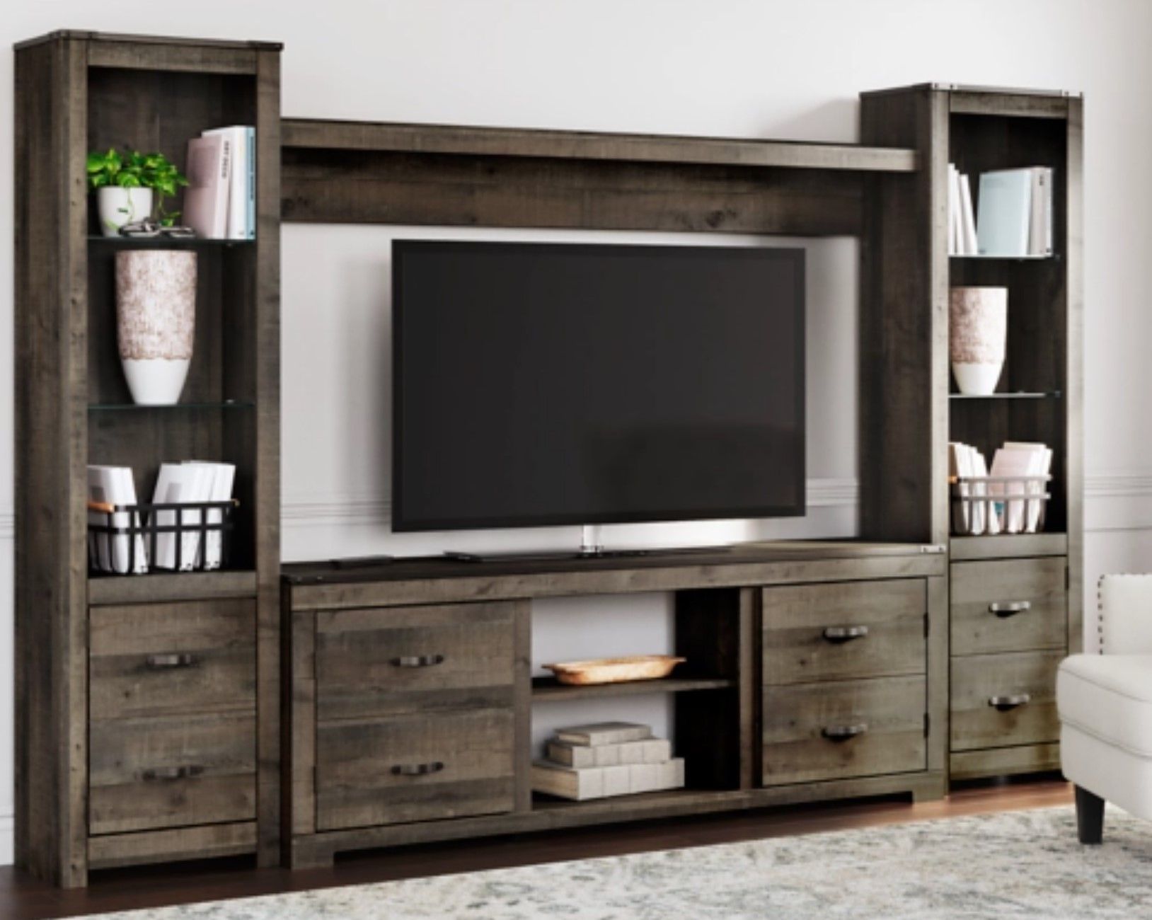 Red Bluff Interiors furniture showroom California wooden entertainment center with mounted TV, shelves, and storage cabinets