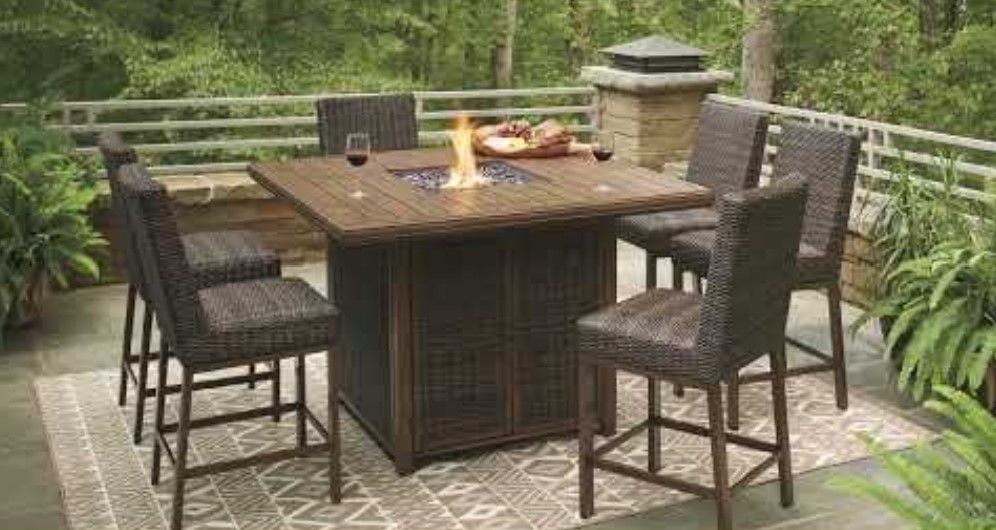 Red Bluff Interiors dining room furniture store outdoor wicker dining set with fire pit table on patio
