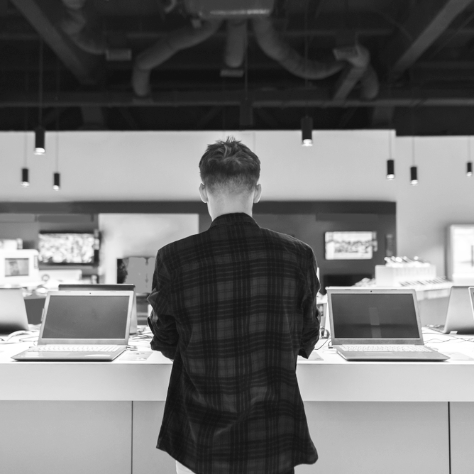 A man performing office equipment maintenance service on a computer.