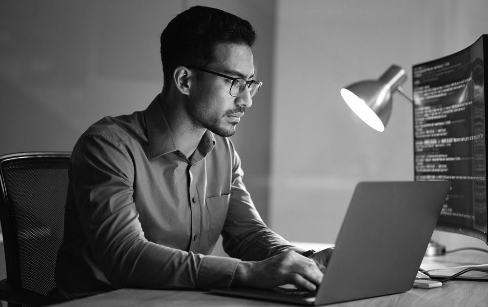 businessman working on his laptop using a managed IT service for enhanced security