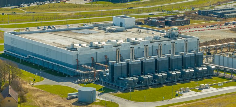 Aerial view of a large Data Center with tall metal equipment and surrounding roads