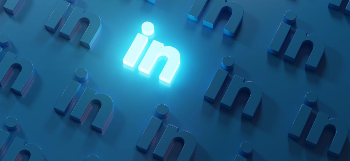 A bright, glowing LinkedIn logo surrounded by many dim, embossed LinkedIn logos on a deep blue background.
