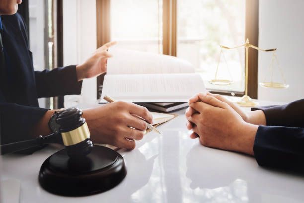 Judge and a client discussing a book.