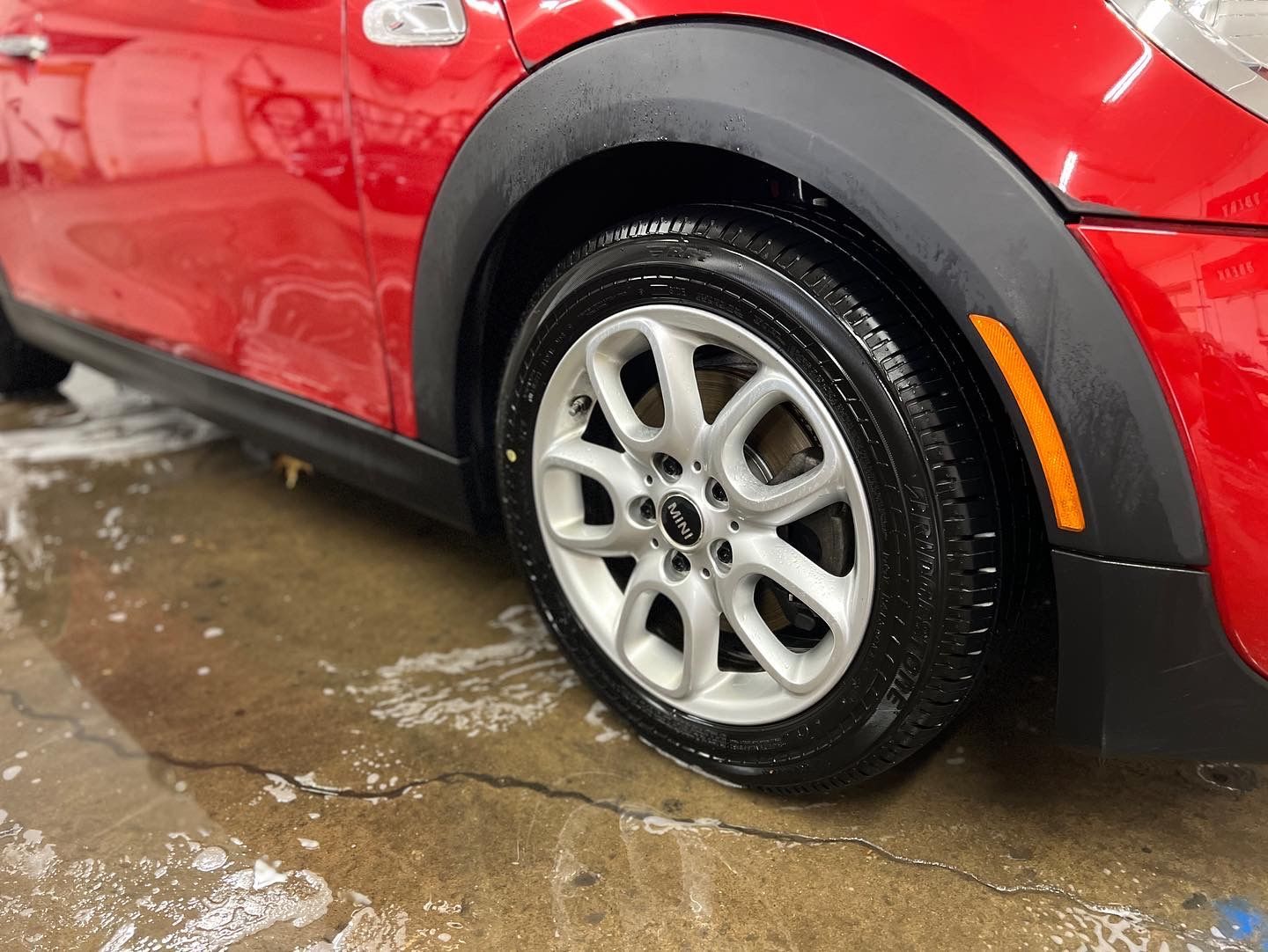 Red Mini Cooper car wheel and fender.