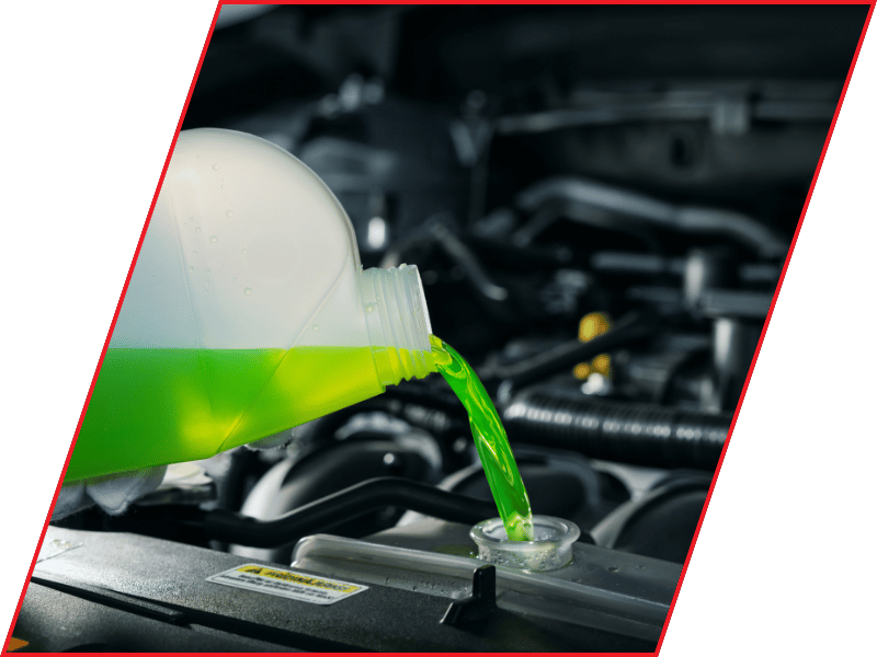 Bright green engine coolant being poured into a vehicle radiator
