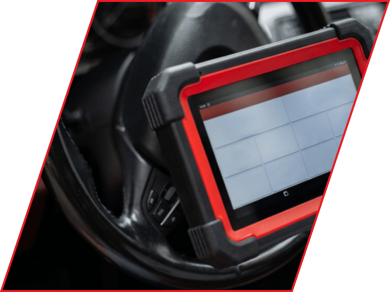 Automotive diagnostic tablet positioned inside a vehicle near the steering wheel