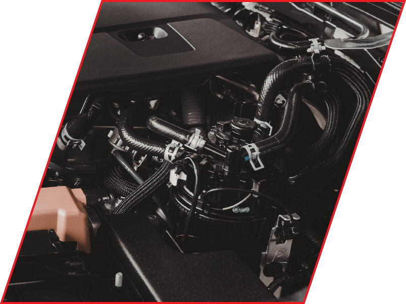 Close-up of electrical components, wiring, and control modules inside a vehicle engine bay
