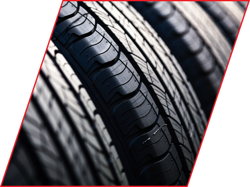 Close-up of automotive tire tread showing deep grooves and tread pattern
