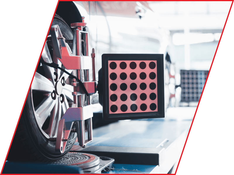 Wheel alignment equipment mounted to a vehicle wheel inside an automotive repair shop