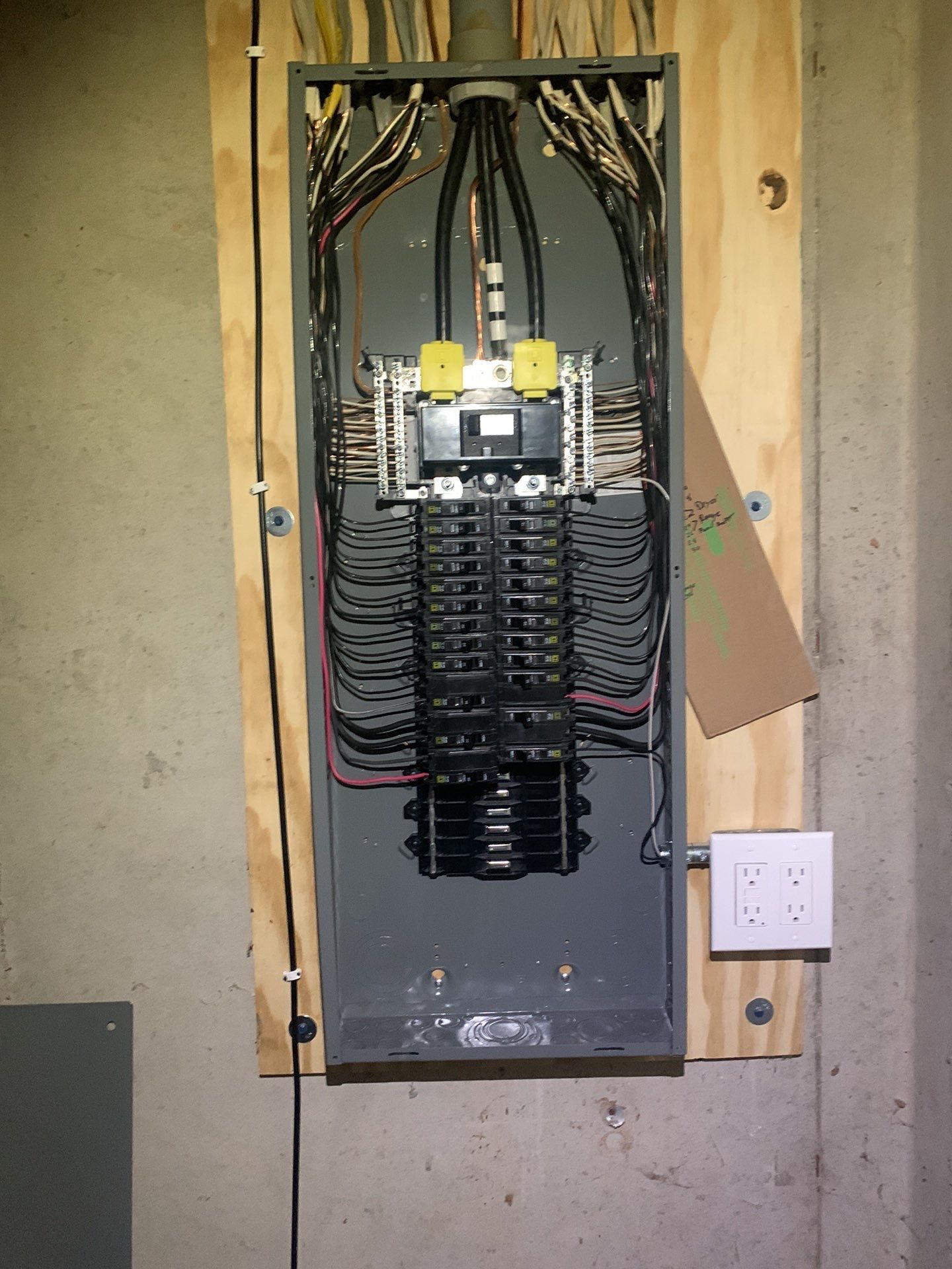 A large electrical box is hanging on a wall