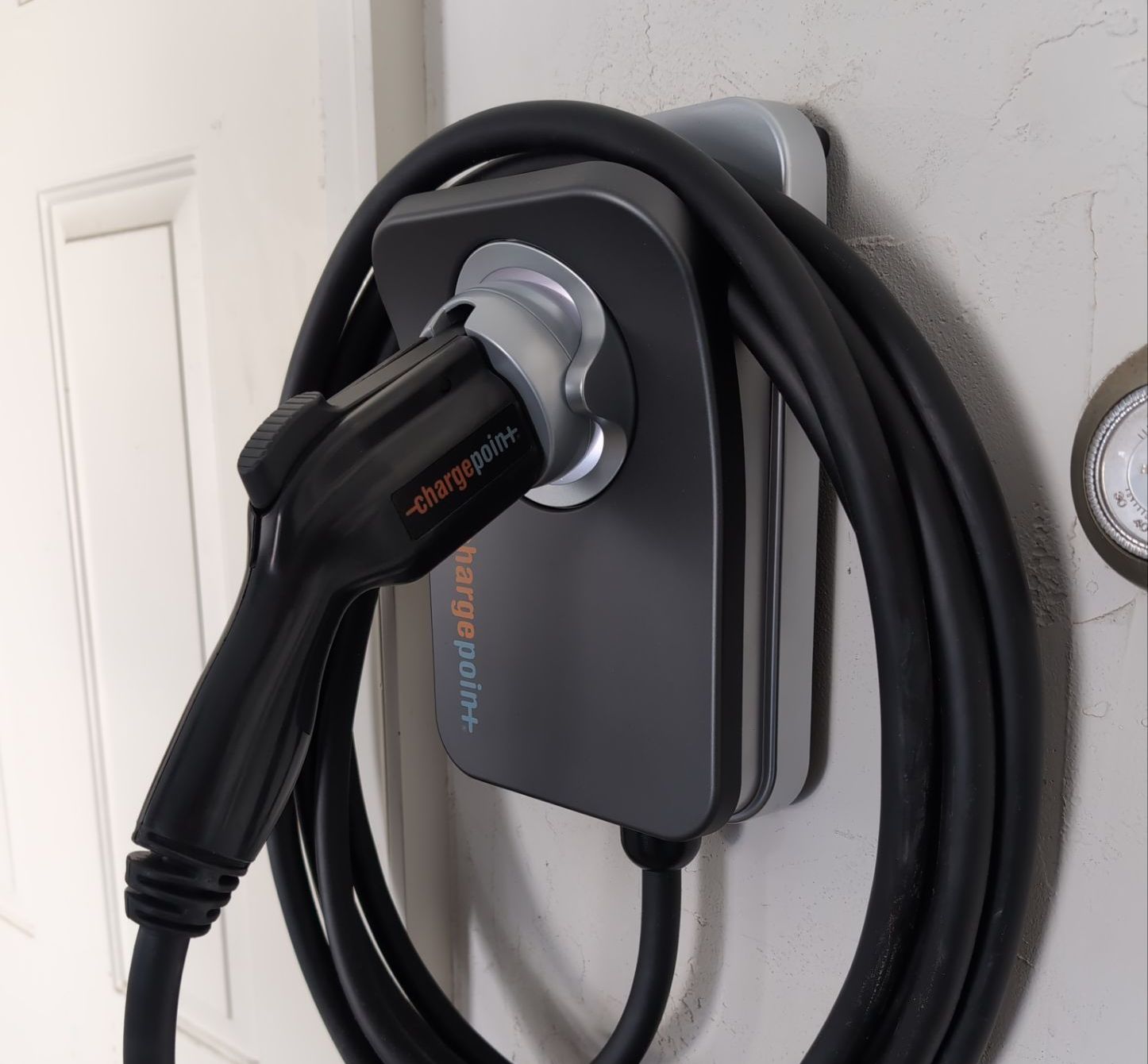 A charging cord is attached to a wall charger