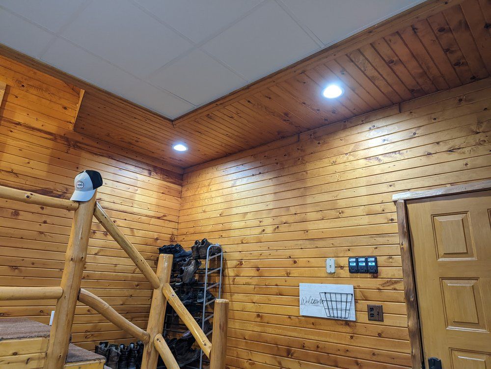A wooden house with a staircase leading up to the second floor.