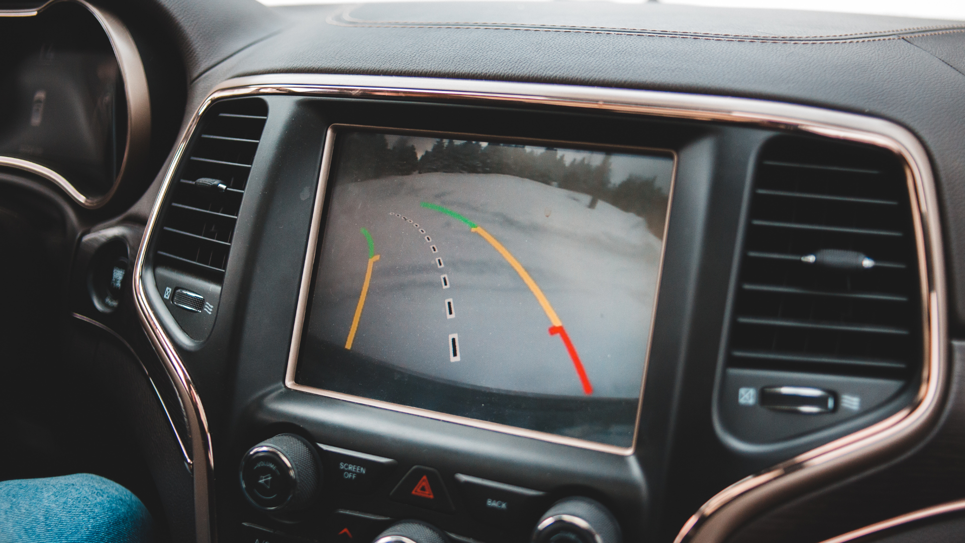 A rear view camera is displayed on the dashboard of a car.