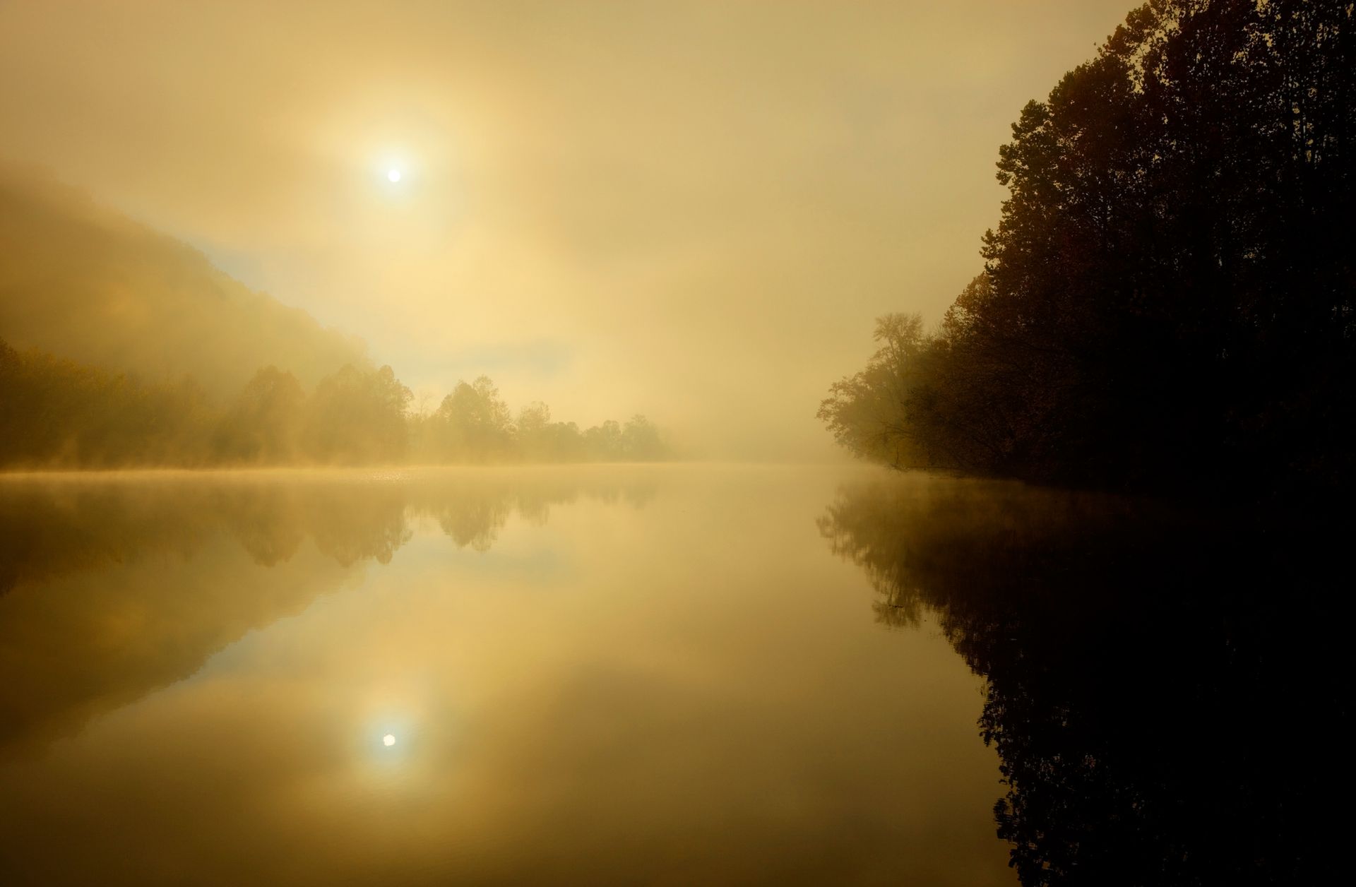 run low over a lake creating a hazy landscape