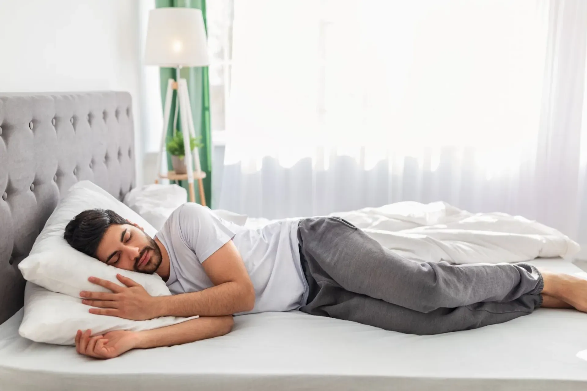 man sleeping peacefully on his side in bed with good posture