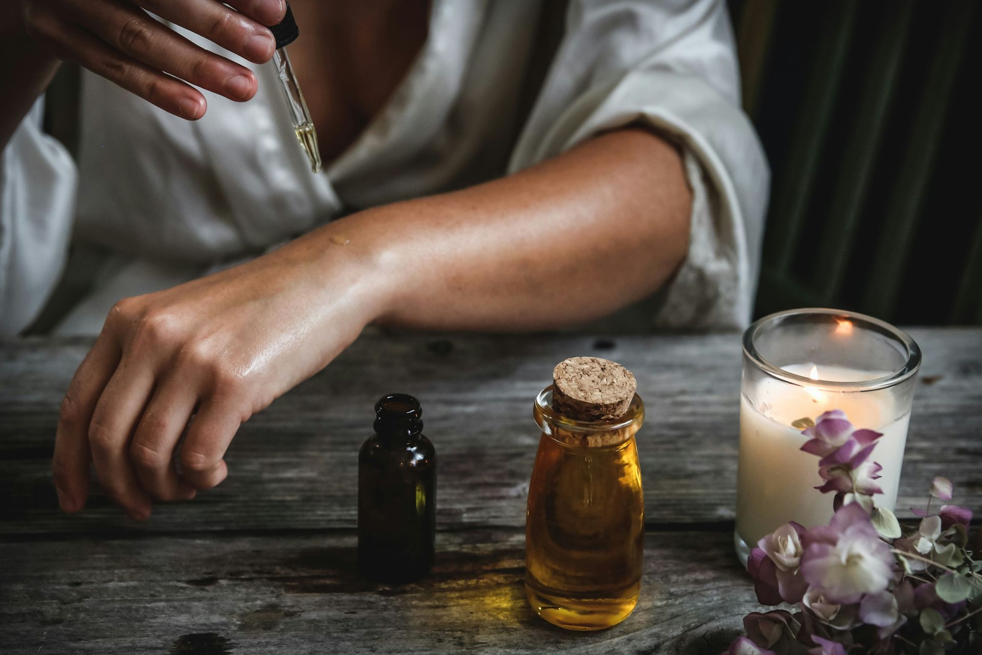 holistic healing oils being applied to the wrist