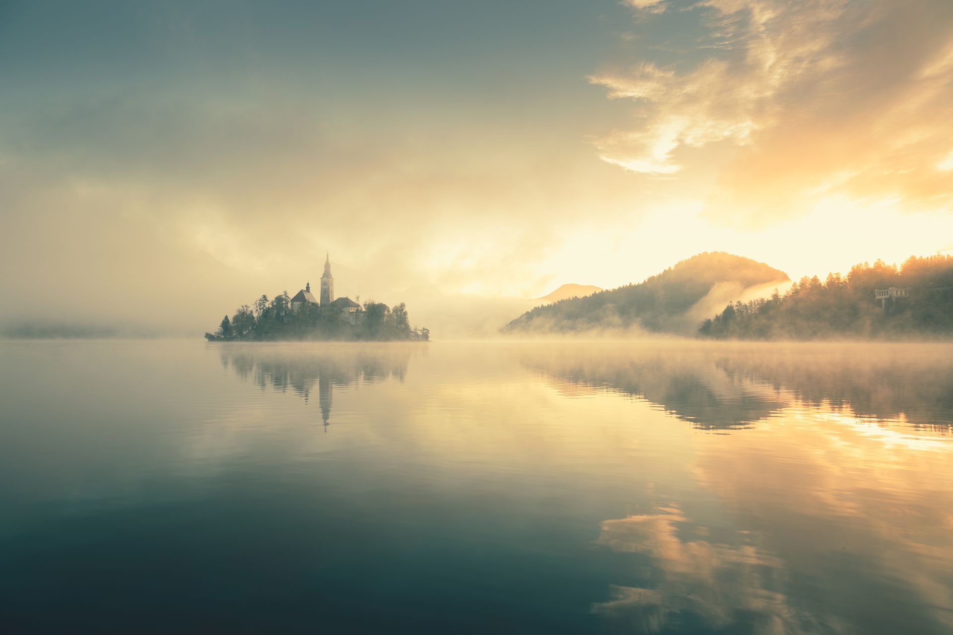 clear lake with reflection of mountains and trees