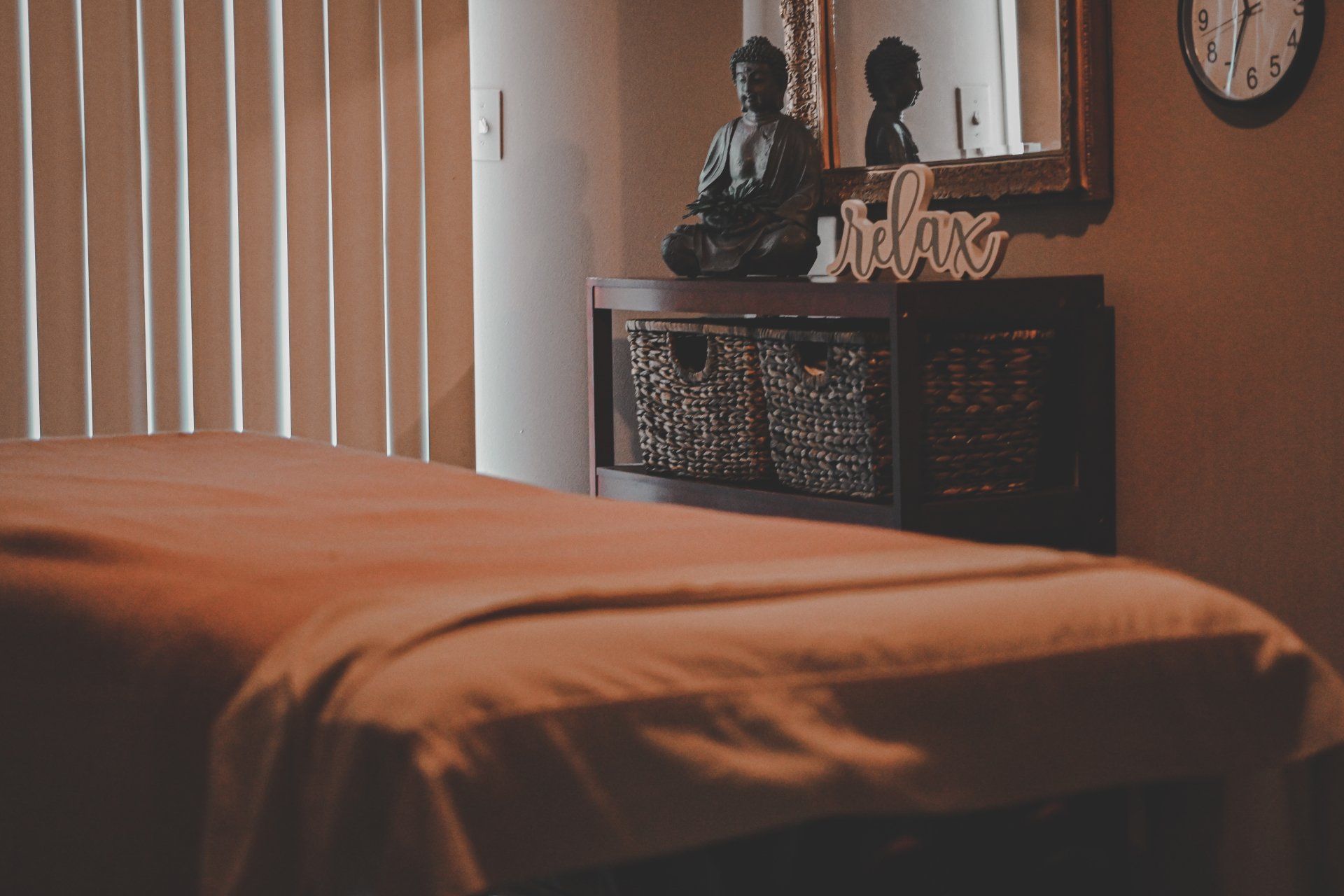 A massage table in a room with a sign that says relax.