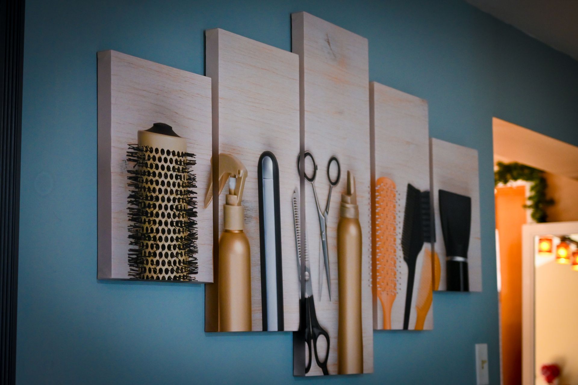 A painting of hair brushes scissors and bottles on a blue wall