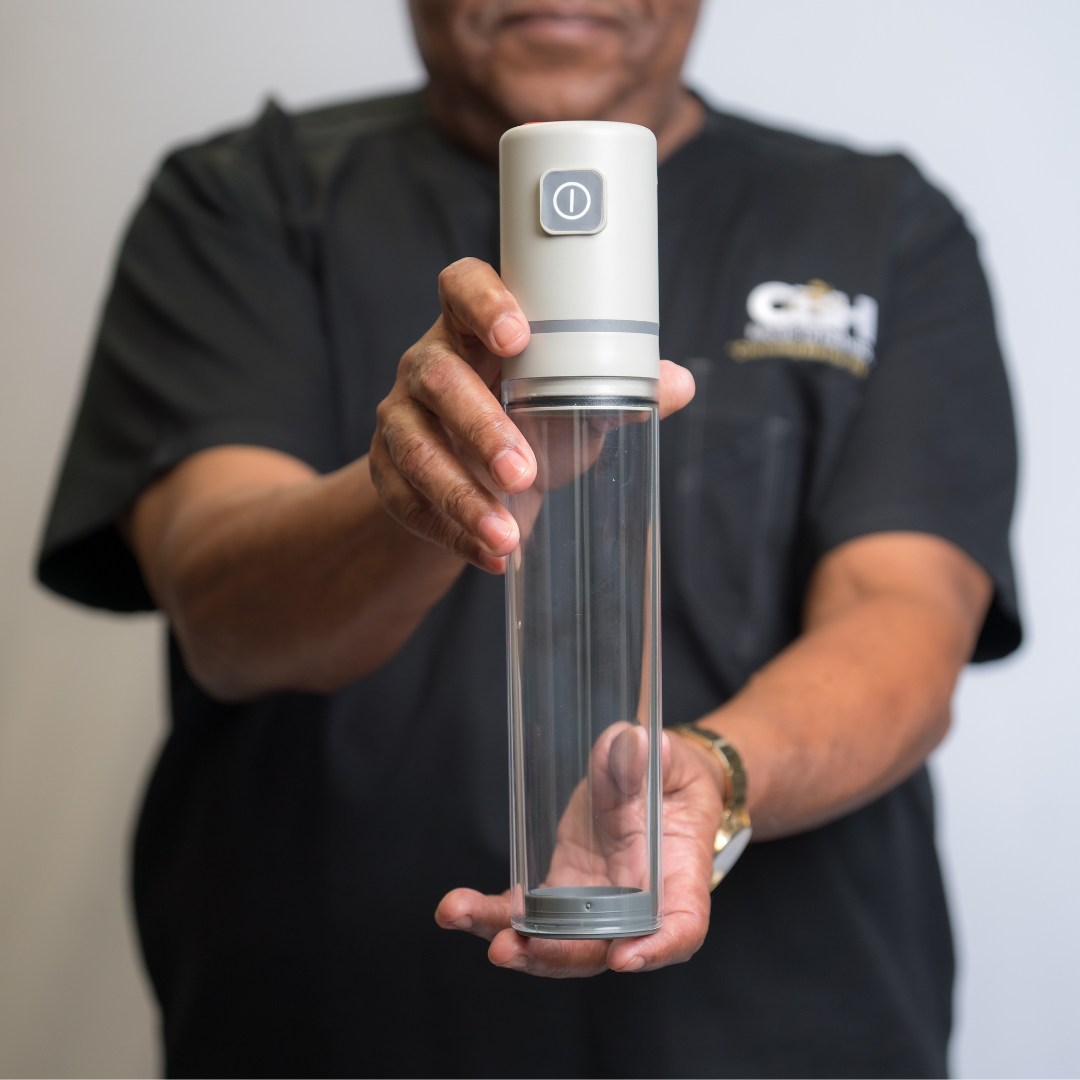 A man in a black shirt is holding a device in his hands