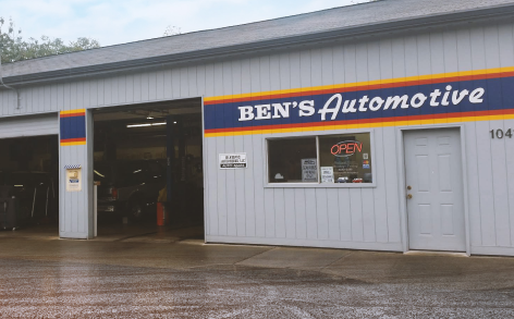 Exterior view of Ben's Automotive, a grey auto repair shop with an open garage bay and