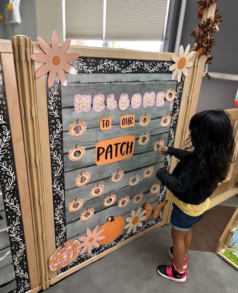 Montessori Child interacts with the seasonal fall display.