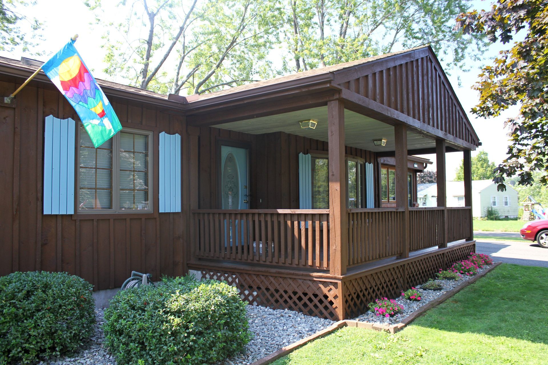 A house with a porch and a flag on it