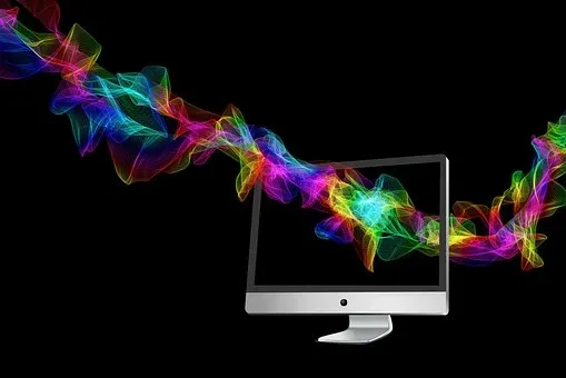 Bild mit Bildschirm und bunter Lichtgirlande zum Thema Web Design, Grafik Design