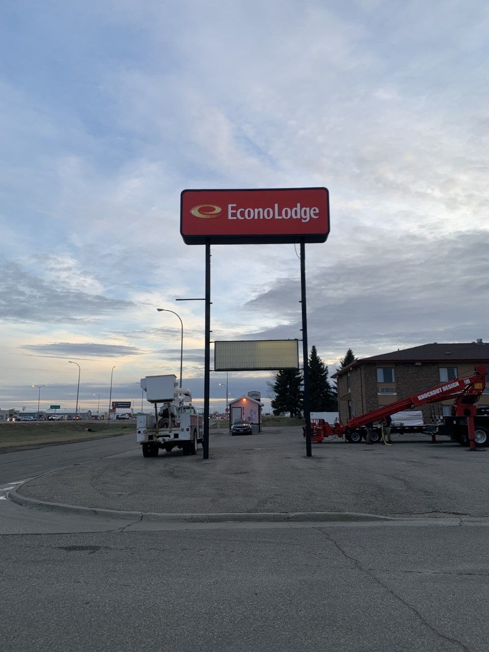 Bonanza sign over gravel lot with a forklift and red equipment at dusk