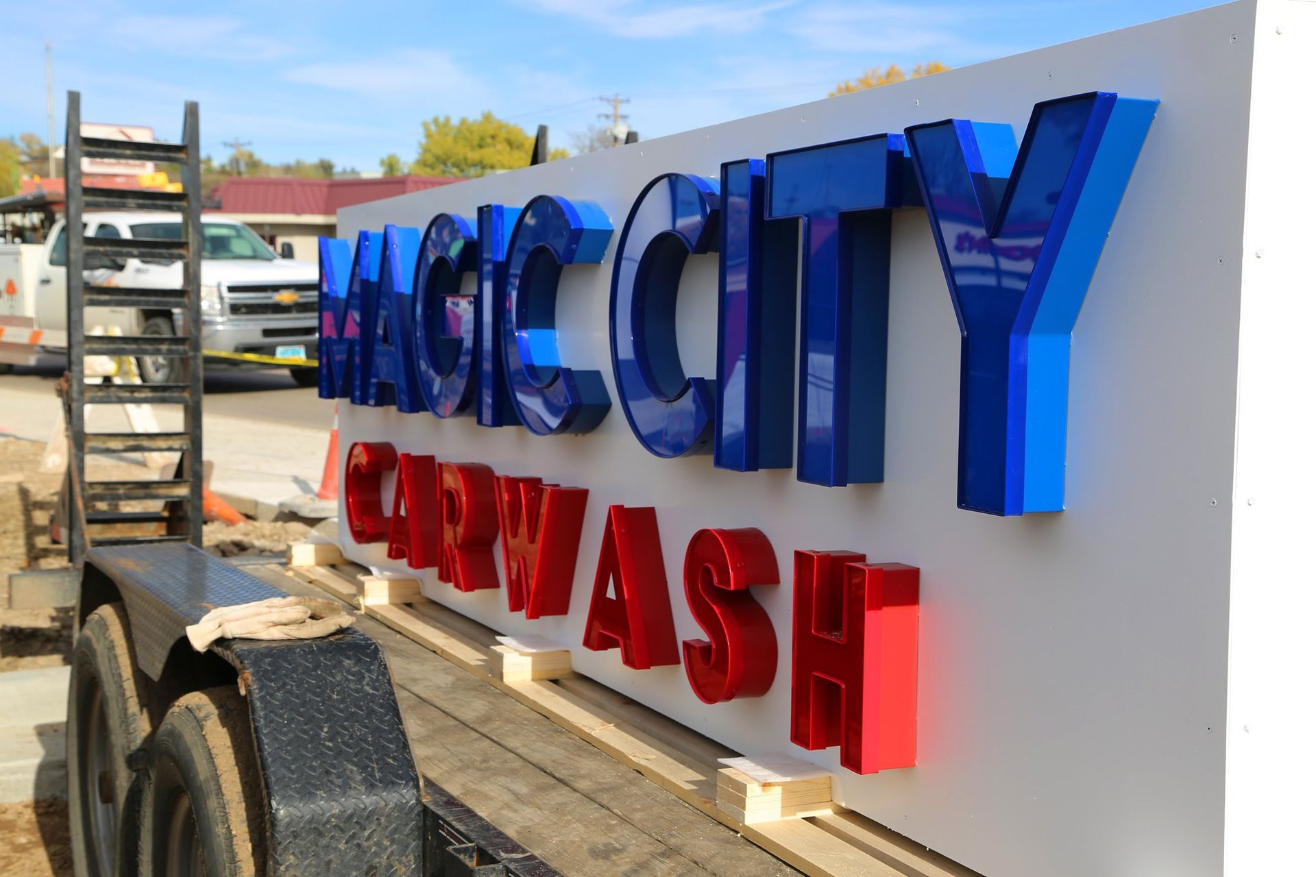Blue and red city wash sign on a trailer in an outdoor lot