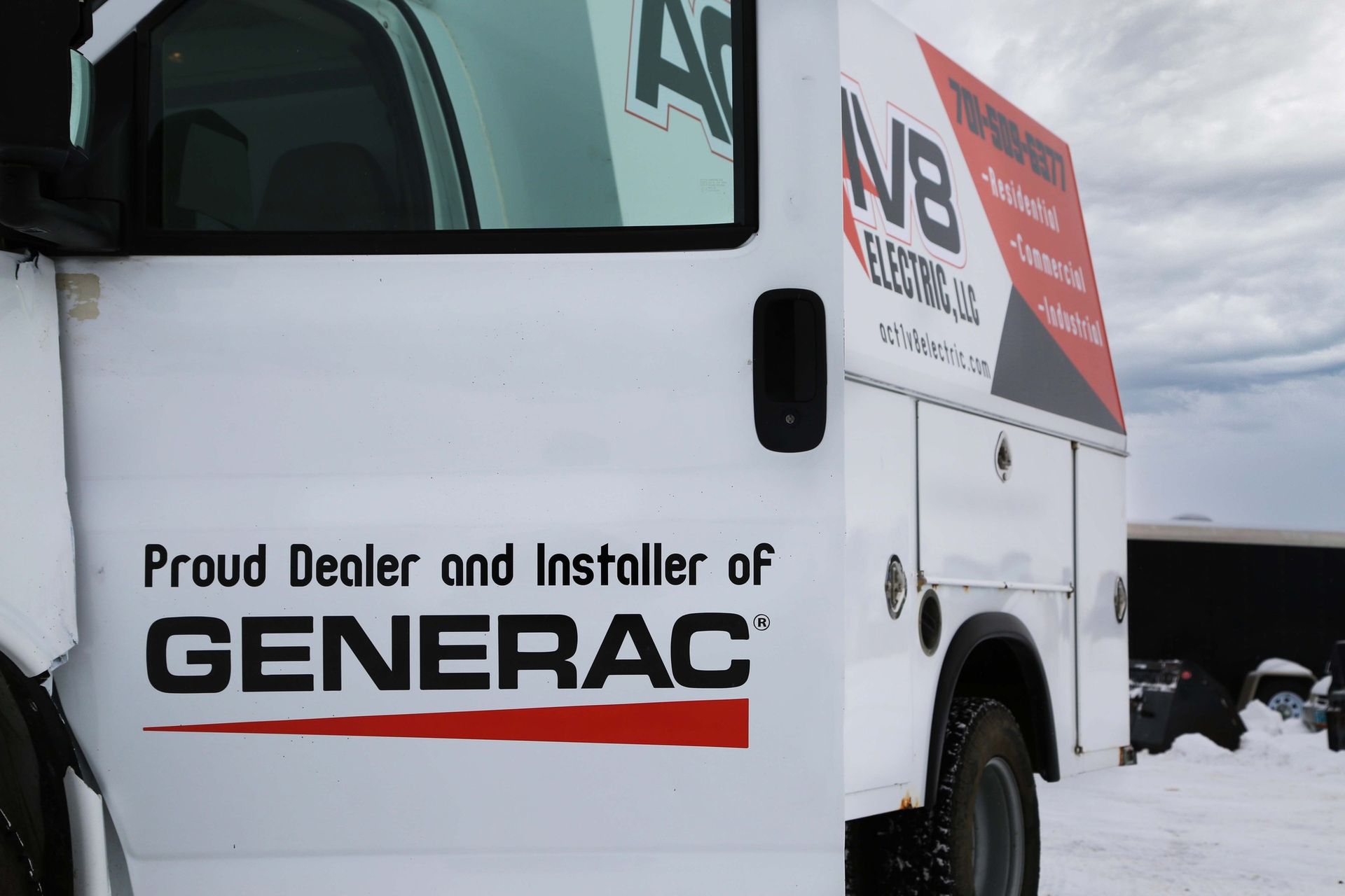 White truck with Generac service branding parked in snow