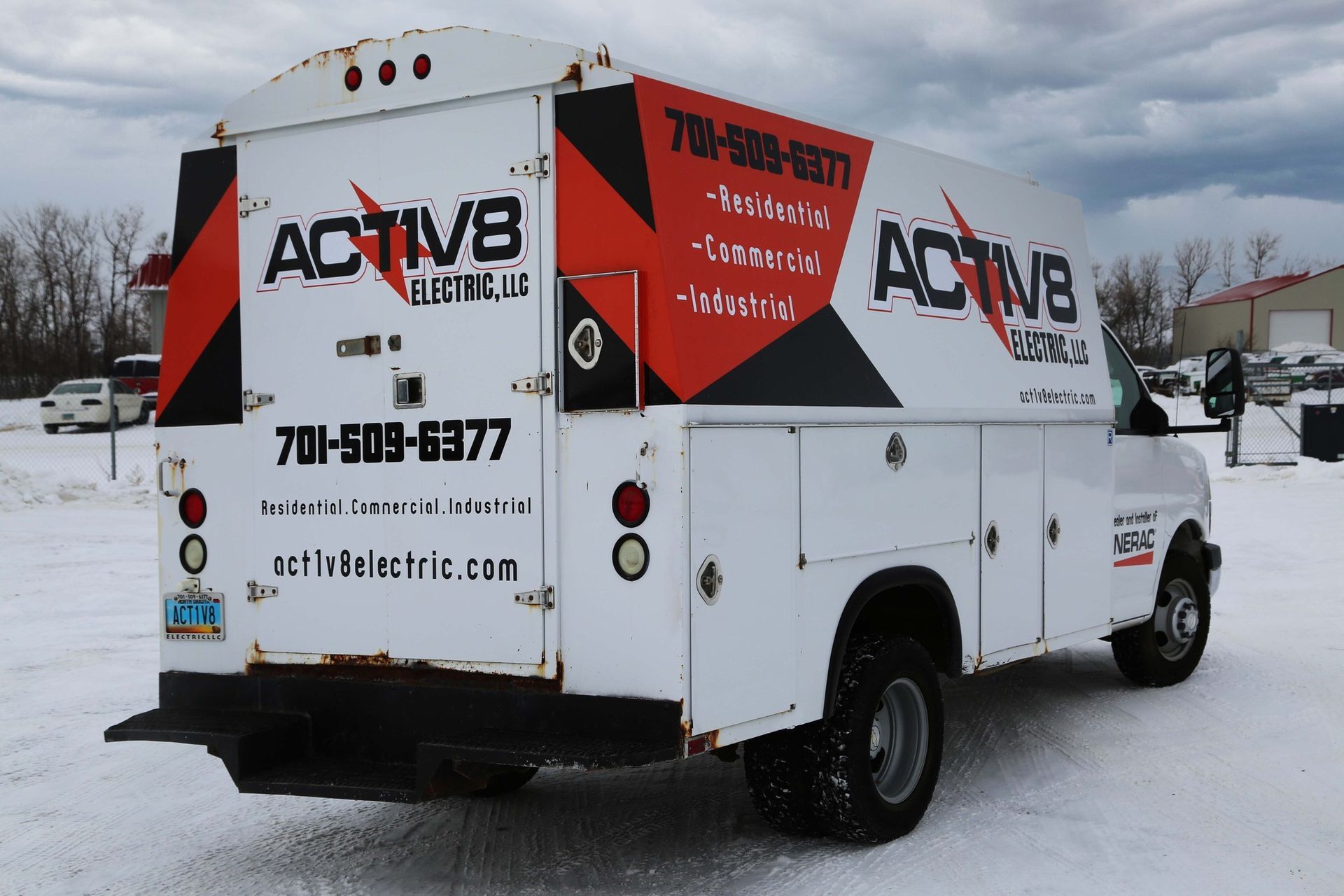 White utility truck with ACTiVB branding parked in a snowy lot, rear and side view.