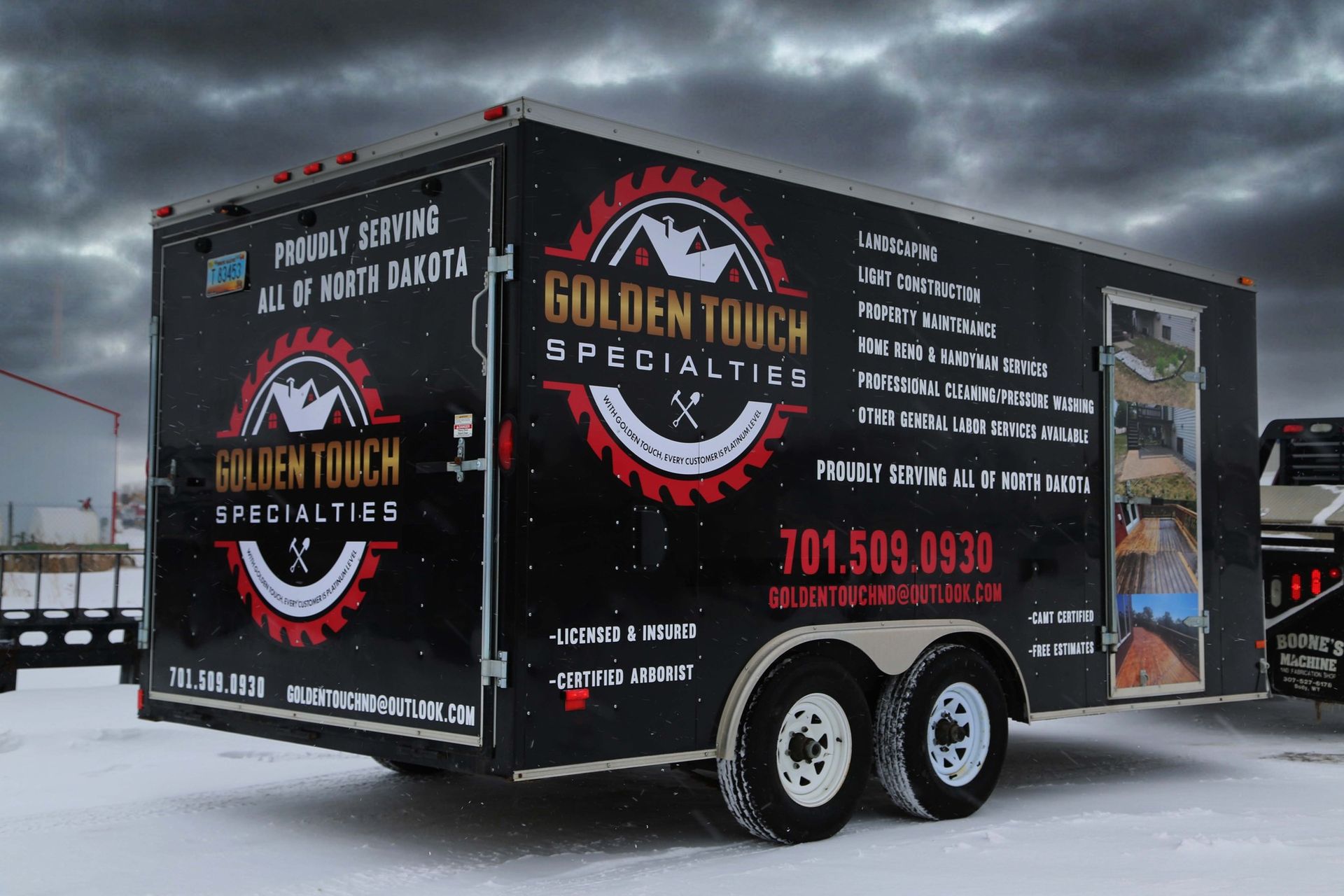 Black Golden State Meats trailer parked on snowy ground, with logo and contact info on the side