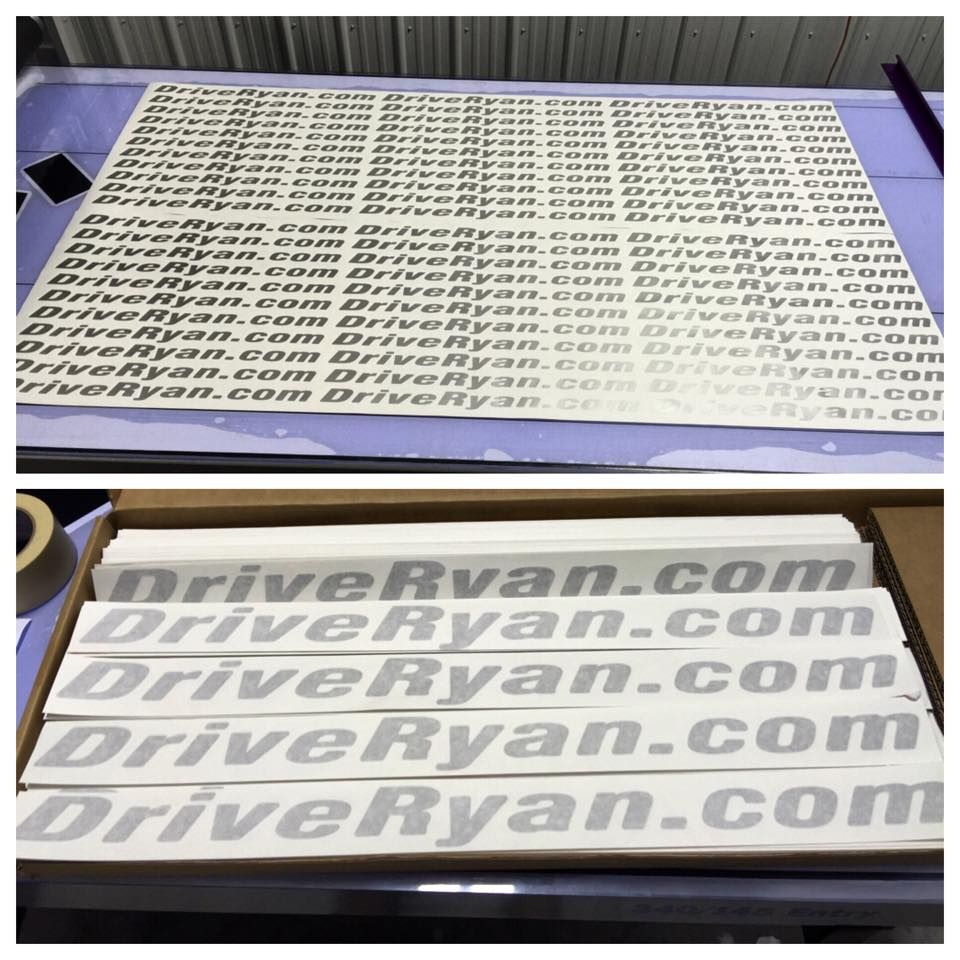 Stacks of printed DriveRyan.com decals on sheets and in a box