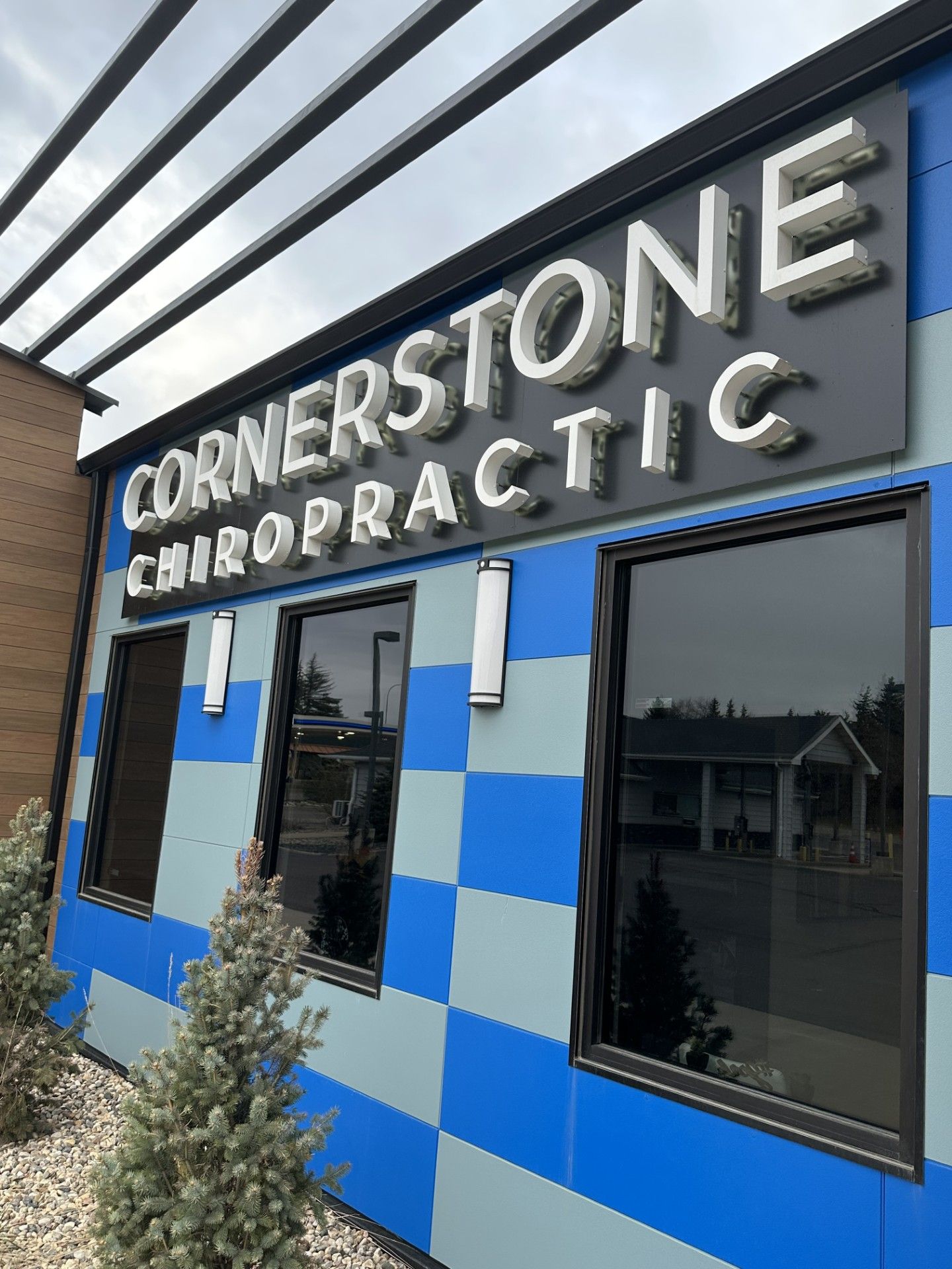 Cornerstone Chiropractic storefront with blue-and-white checkered exterior and black windows