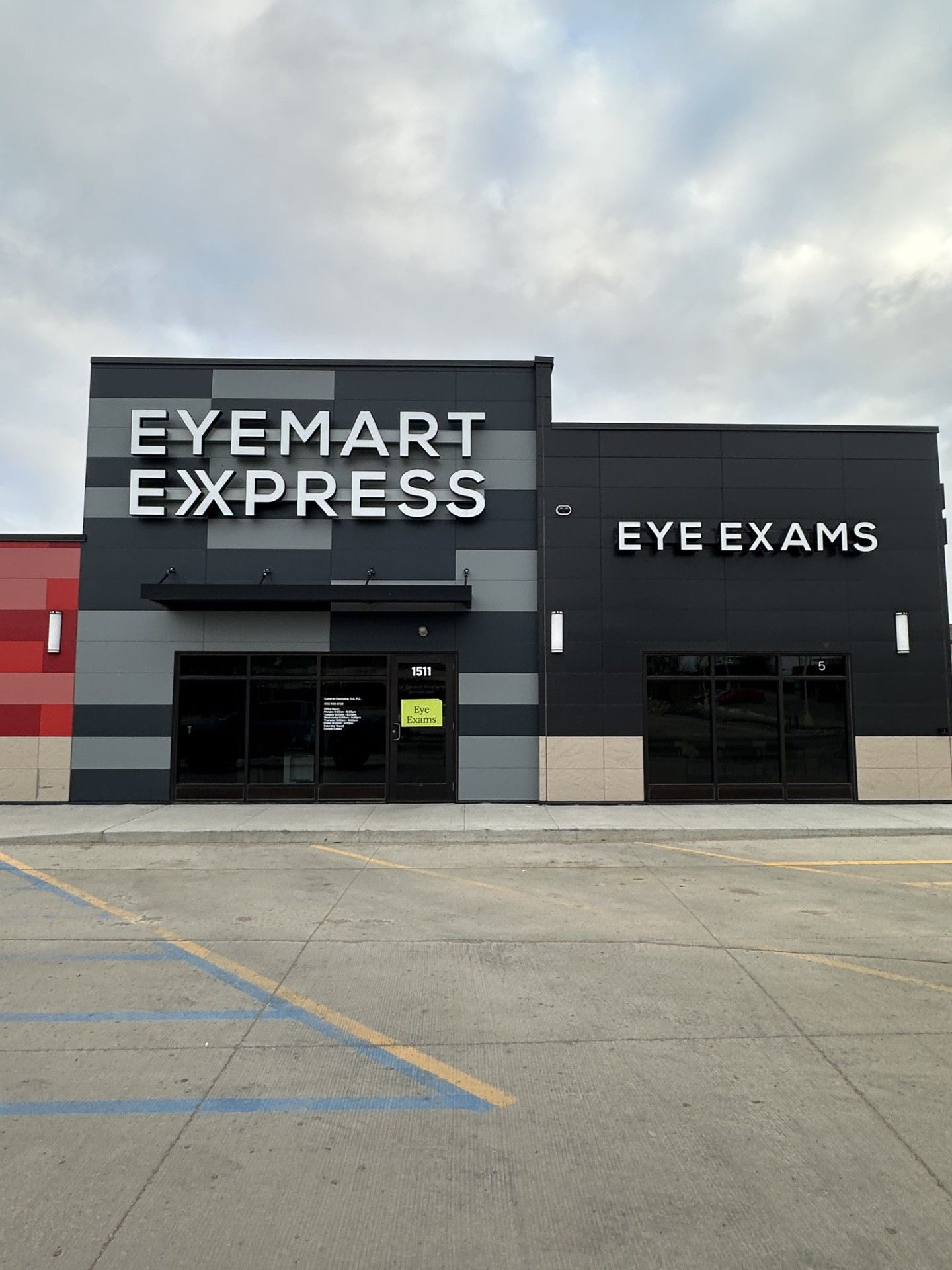 Eyemart Express storefront with eye exams sign on a cloudy day