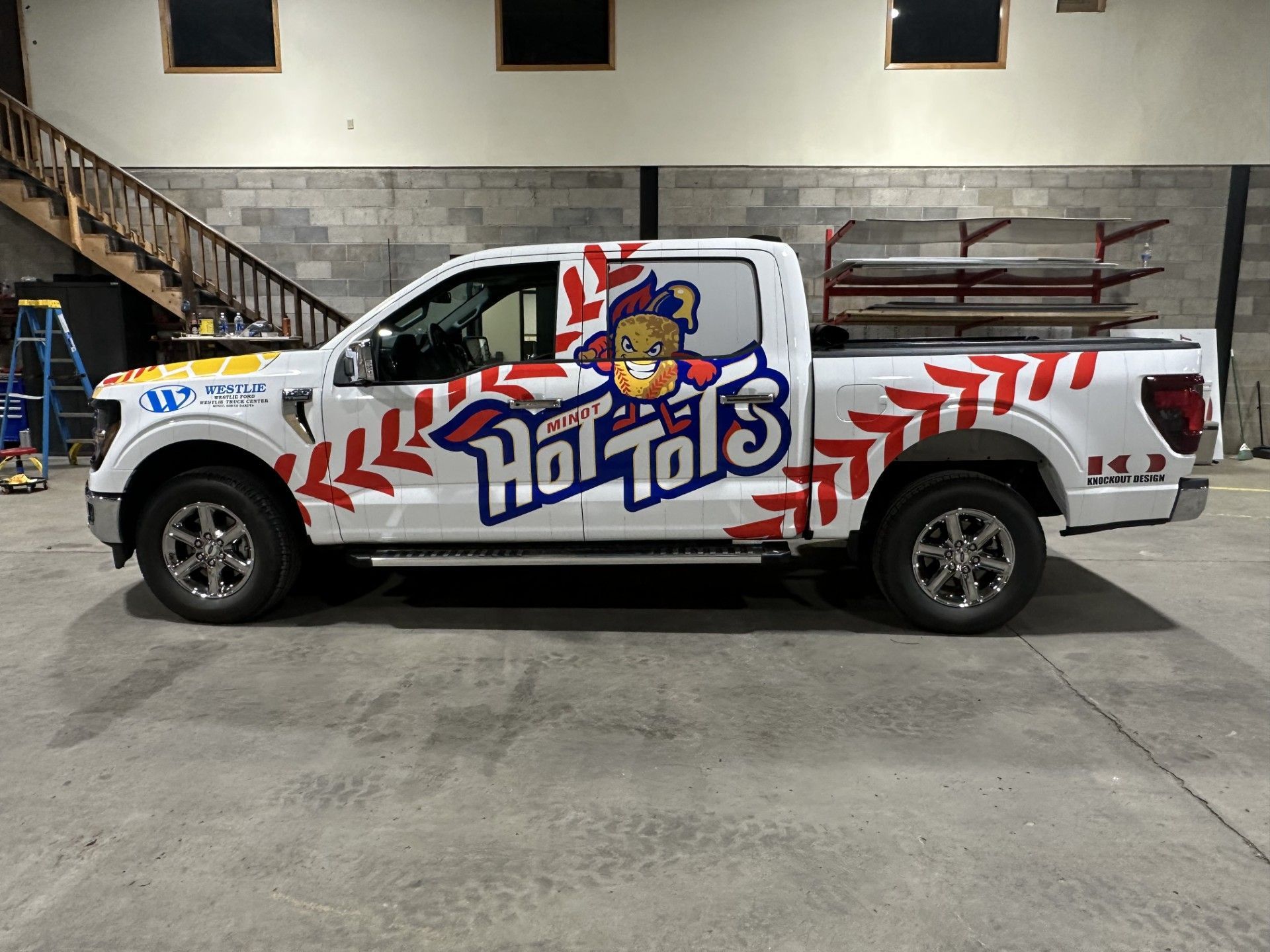 Custom Hot Tots pickup truck with red-and-white graphics parked indoors
