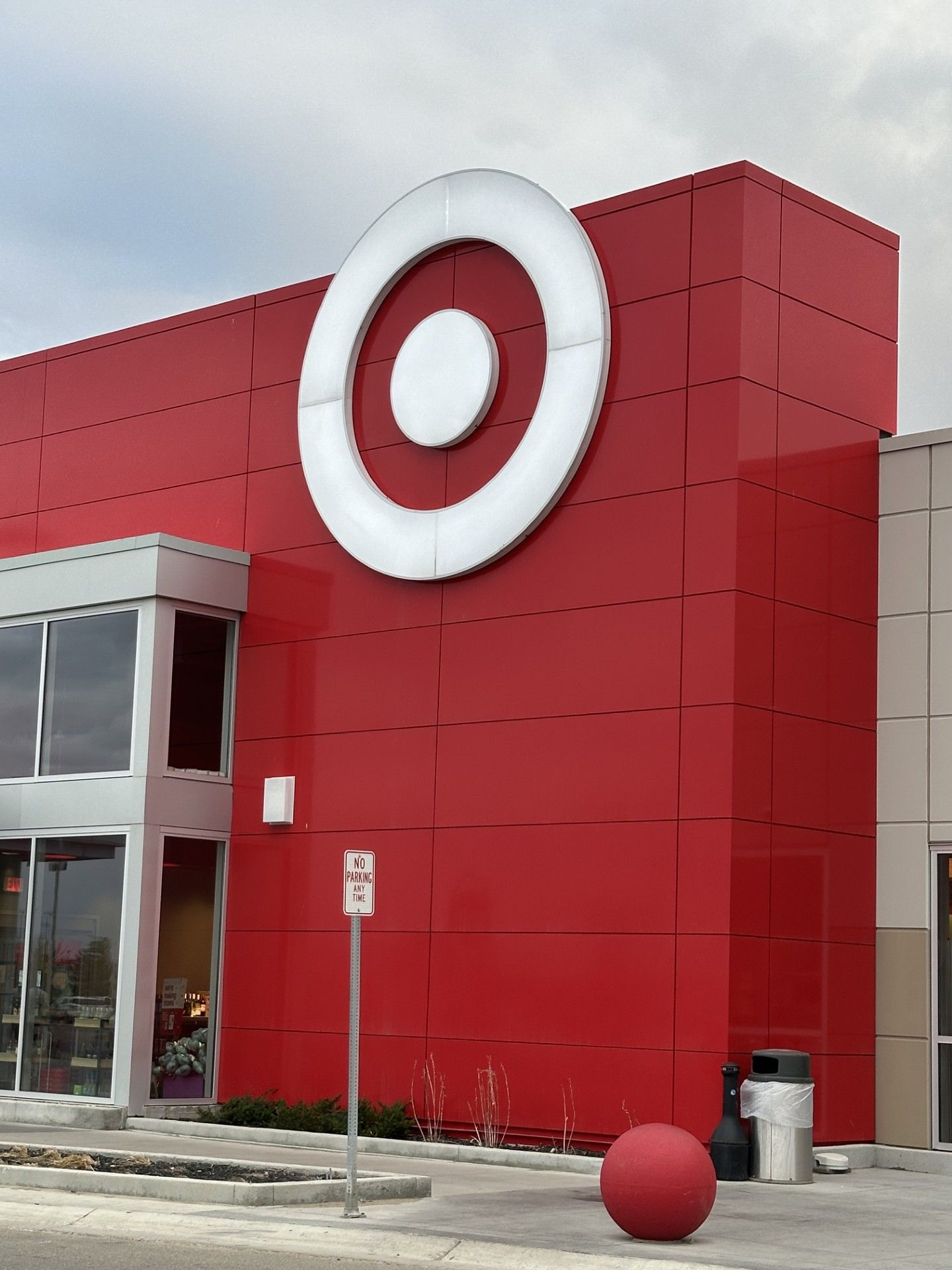 Red storefront with large white target logo and a red sphere outside at the entrance.