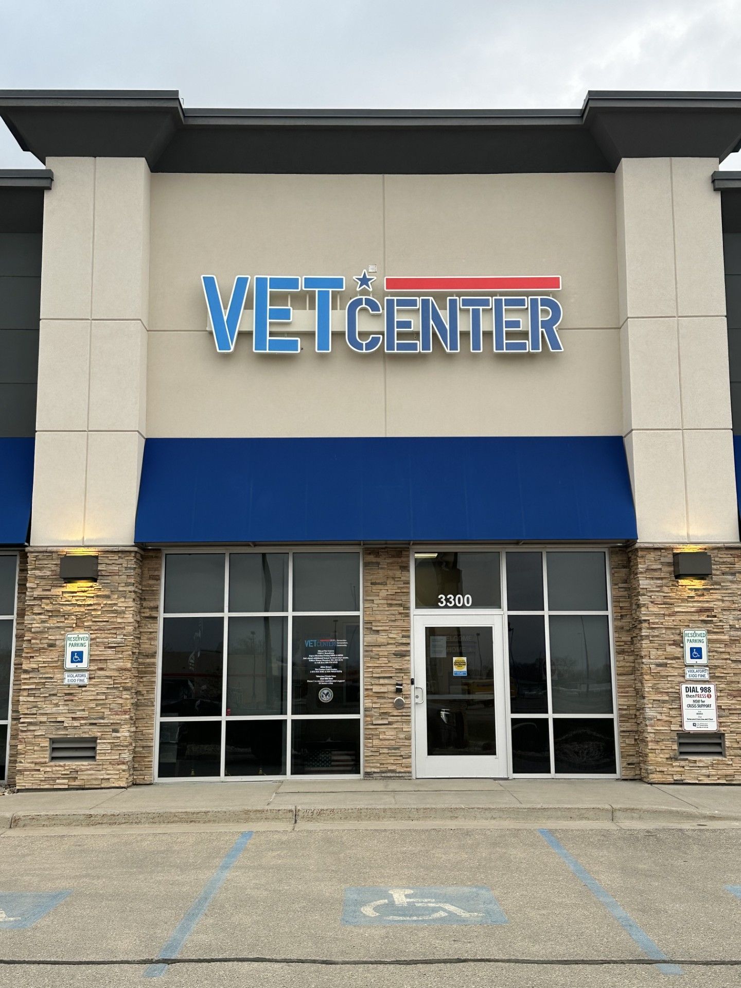 Vet Center storefront with blue awning, glass entrance, and stone facade in a shopping plaza