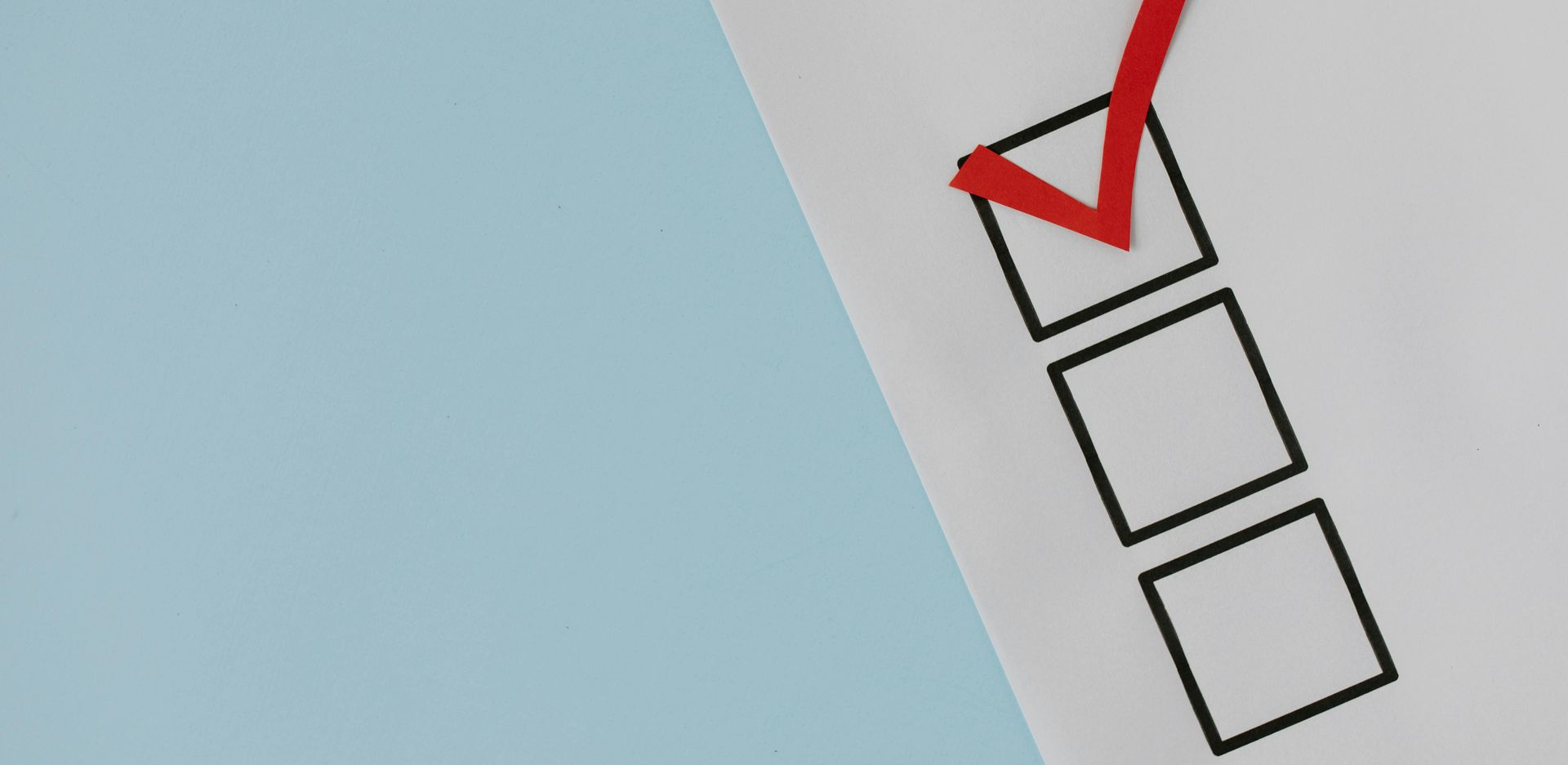 A red checkmark fills the top box of three vertical, empty, black-outlined squares on a white background.