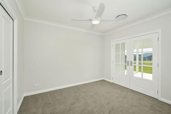 An Empty Room With A Ceiling Fan and French Doors | Mid-North Coast, NSW | BDM Constructions