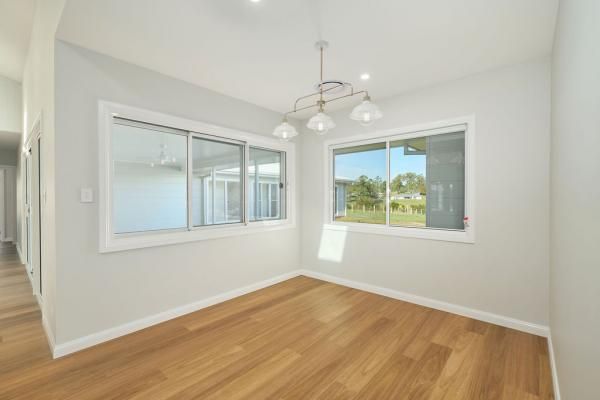 An Empty Room with Hardwood Floors and Two Windows | Mid-North Coast, NSW | BDM Constructions